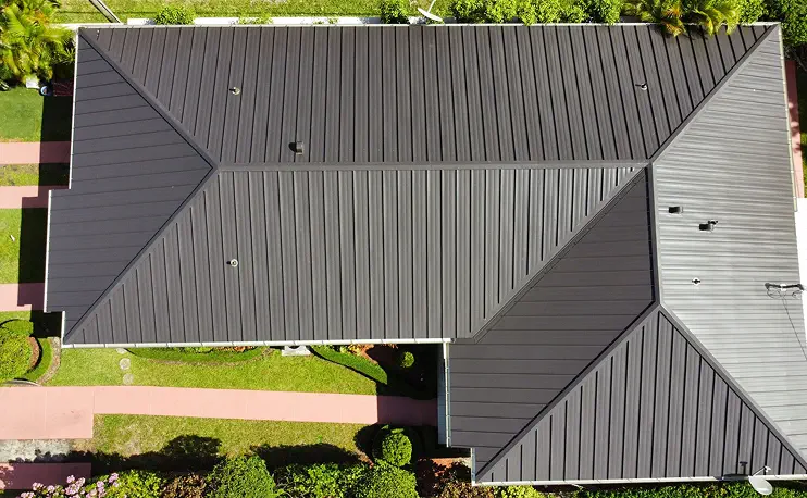 Aerial view of a home with a dark gray standing seam metal roof — Roofing Experts Services, Miami-Dade County