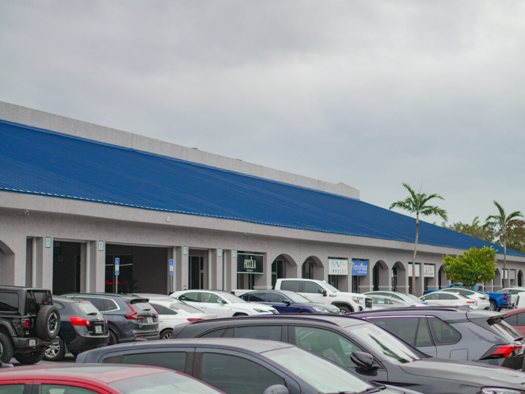 Royal blue standing seam metal roof on a retail plaza on NW 87th Ave in Doral, FL